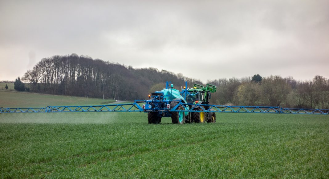 Farmer spraying a field